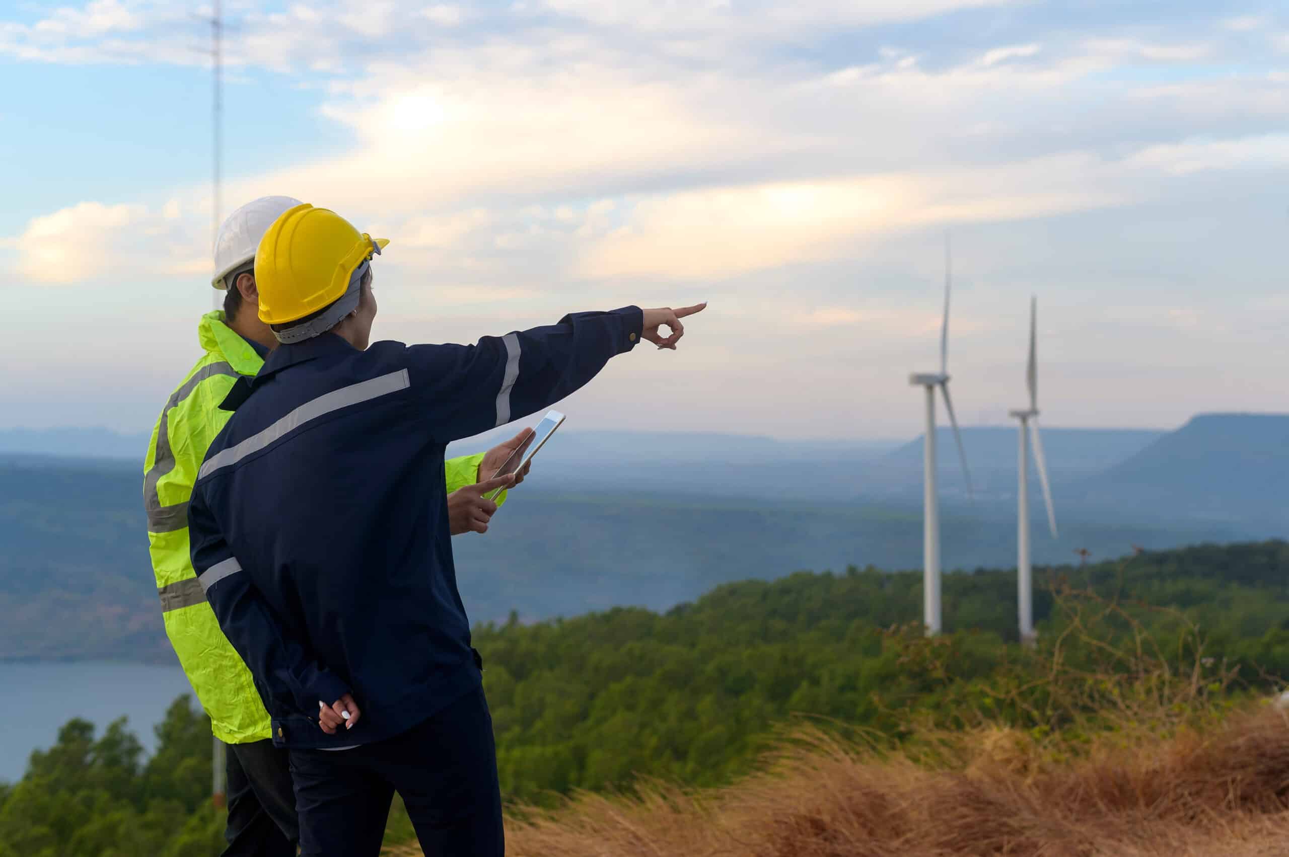 Renewable energy professionals reviewing wind and clean energy project requirements